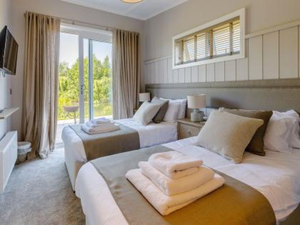 Ludlow Fishing Lodges in Ashford Bowdler for rent with wood burner and views across the fishing pool