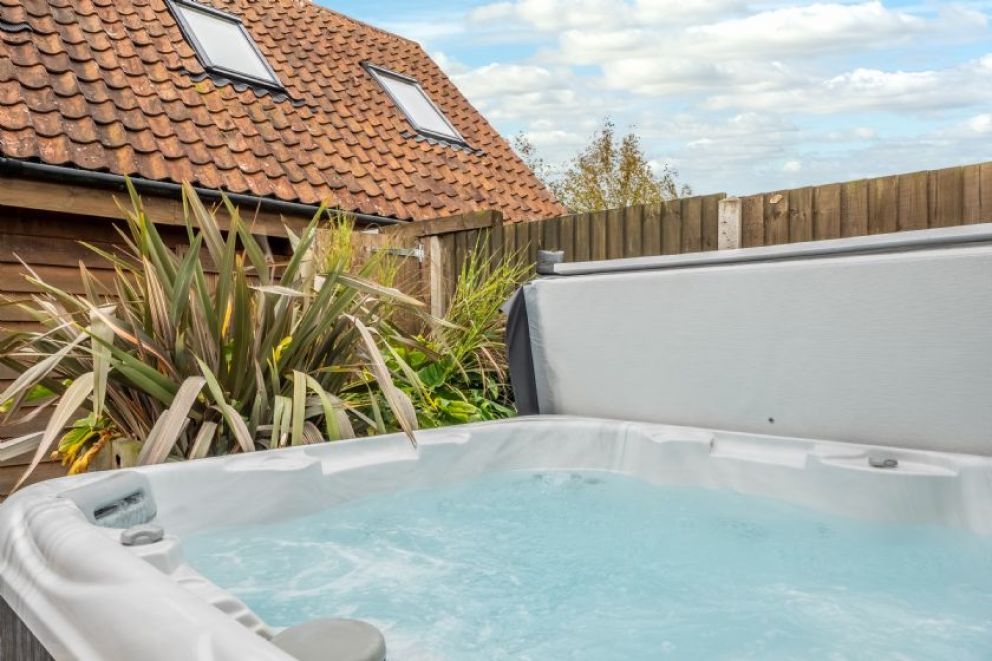 Cartshed Lodge, Hoveton in the heartland of the Norfolk Broads - adult only lodge for rent with hot tub, sun loungers and barbecue