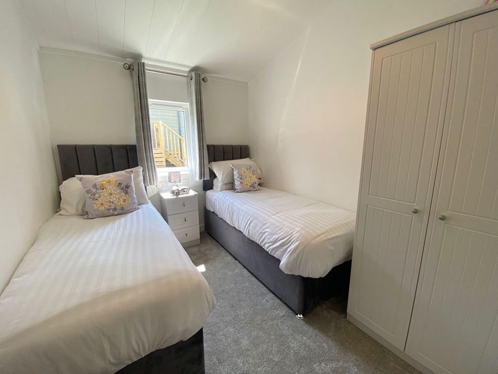 The Lake House twin bedroom at Docker Holiday Park 