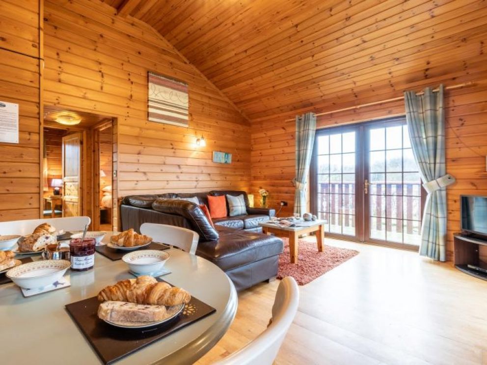 Cabins at Clovelly Lakes - lakeside lodges for rent. Open plan living with views over the lake