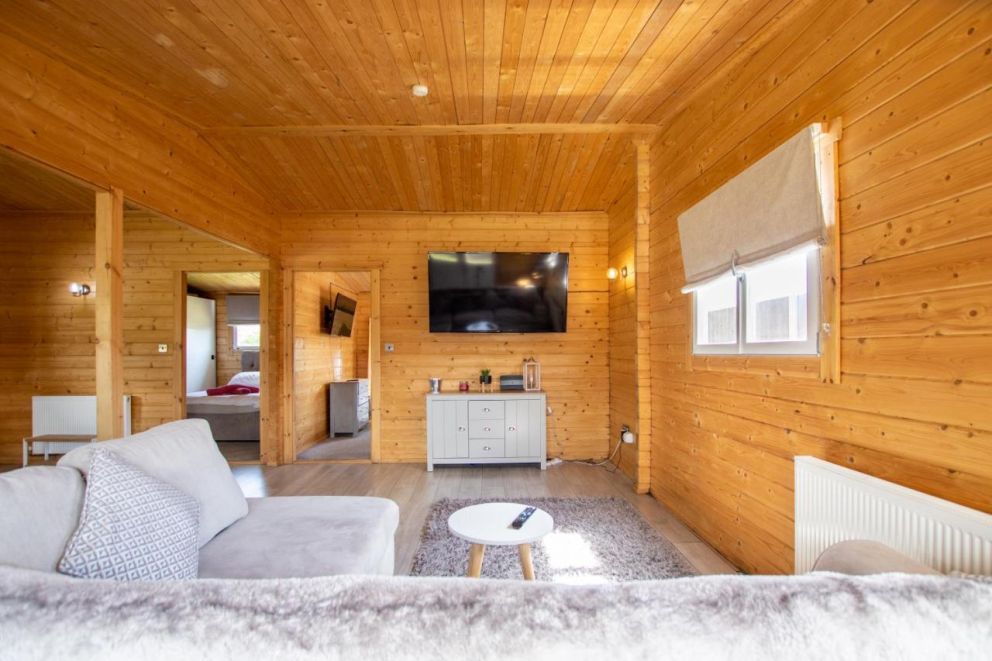 Rural Log Cabin in Slindon - pet friendly accommodation, with hot tub and fishing lake